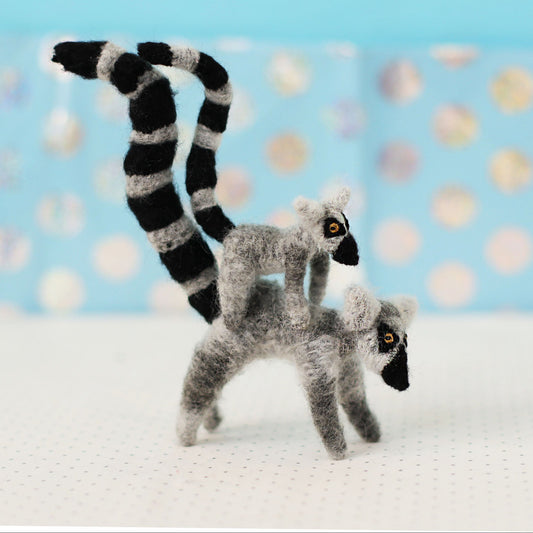 Handmade ring-tailed lemur collectible plush — adult lemur carrying a baby on its back, miniature soft sculpture with striped tails and embroidered details.