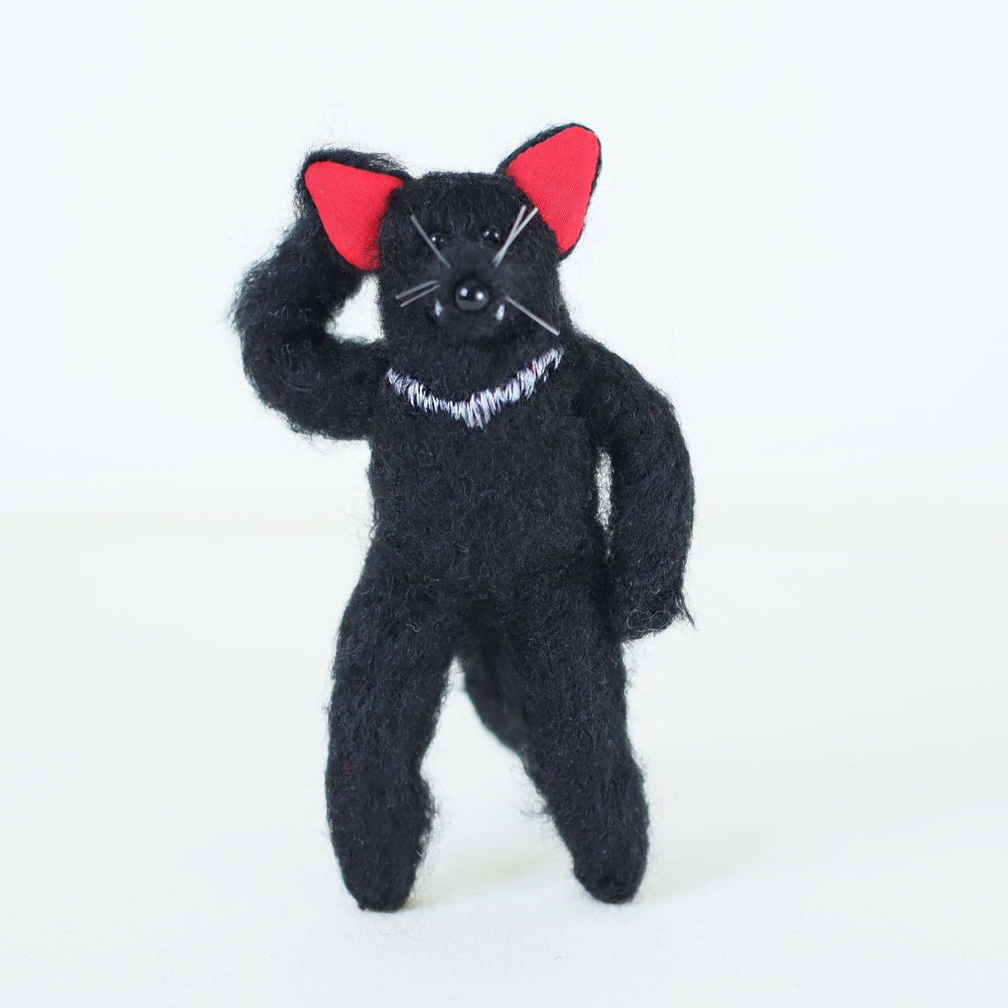 Artisan Tasmanian devil plush doll standing upright in a characterful, playful pose, with embroidered white chest detail.