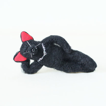 Handmade Tasmanian devil plush doll, lying on its side in a relaxed pose — hand-sewn stuffed animal, artisan soft toy, collectible plush.