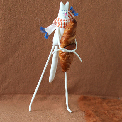 Handmade white cat plush holding a croissant